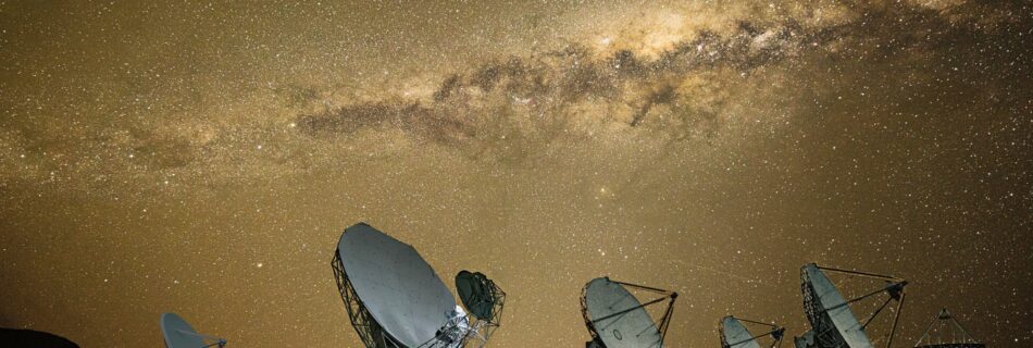 large antennas aligned under a night sky