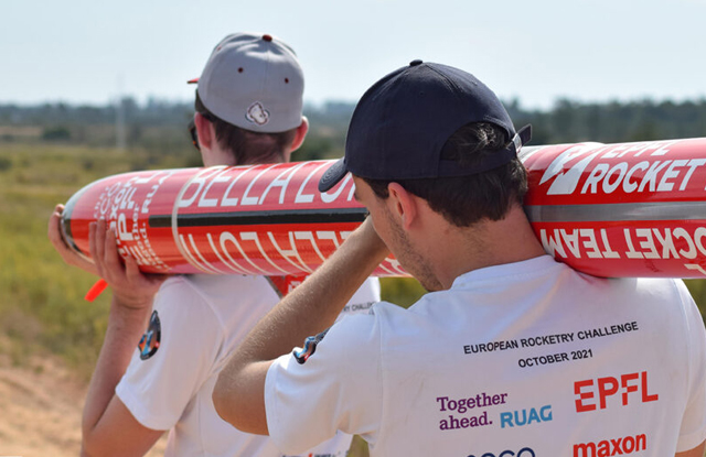 rocket team members carrying a rocket