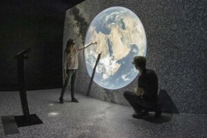 photo of the half cave with an image of earth in the eM+ lab