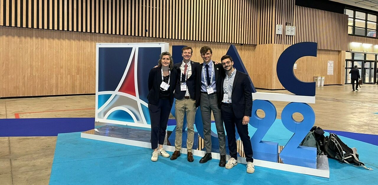 eSpace team in front of the IAC logo
